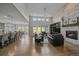 Bright living room featuring a stone fireplace, built-in shelving, and hardwood floors at 9433 Torrey Way, Arvada, CO 80007