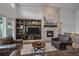 Living room with stone fireplace, and built-in shelves that create a warm and inviting atmosphere at 9433 Torrey Way, Arvada, CO 80007