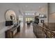 Spacious living room with hardwood floors, stone fireplace, and large windows with abundant light at 9433 Torrey Way, Arvada, CO 80007