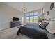 Bright primary bedroom with backyard views, modern light fixture, and neutral decor at 9433 Torrey Way, Arvada, CO 80007