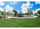 Community playground with colorful equipment, surrounded by lush green grass, under a beautiful blue sky at 9433 Torrey Way, Arvada, CO 80007