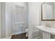 Stylish powder room featuring a modern pedestal sink and neutral color palette at 9433 Torrey Way, Arvada, CO 80007