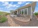 Beautiful back exterior view with covered patio, rock detail and well-kept lawn at 9433 Torrey Way, Arvada, CO 80007