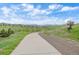 Scenic view of walking path, lush greenery, and picturesque neighborhood homes at 9433 Torrey Way, Arvada, CO 80007