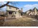 Expansive backyard featuring a large deck with pergola, grass and mature trees at 11362 W Frost Ave, Littleton, CO 80127