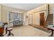 Bright living room with a large bay window, stairs to the second floor, and hardwood floors at 11362 W Frost Ave, Littleton, CO 80127