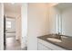 Bright bathroom featuring a gray countertop vanity with an oval sink and a large mirror at 24704 E Pacific Pl, Aurora, CO 80018