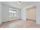 Well-lit room with hardwood flooring, a large window, and fresh white paint at 24704 E Pacific Pl, Aurora, CO 80018