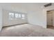 Spacious bedroom with plush carpeting, recessed lighting, and multiple windows at 24704 E Pacific Pl, Aurora, CO 80018