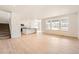 Open concept living room and kitchen featuring hardwood floors and abundant natural light at 24704 E Pacific Pl, Aurora, CO 80018