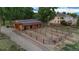 Aerial view of property with barn, horse area, fencing, and residential house, showing country property at 7130 Independence St, Arvada, CO 80004