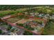 Aerial view of a large equestrian property, outlined, with a house, barn, pastures, and riding arena at 7130 Independence St, Arvada, CO 80004