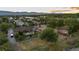 Lovely aerial view of a home with horse property, including a stable and riding arena, set against a mountain backdrop at 7130 Independence St, Arvada, CO 80004