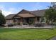 Beautifully landscaped backyard boasts a spacious patio with a covered seating area, perfect for outdoor entertaining at 7130 Independence St, Arvada, CO 80004