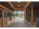 Well-maintained barn interior with multiple horse stalls, brick flooring, and ample natural light at 7130 Independence St, Arvada, CO 80004