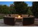 Inviting outdoor fire pit surrounded by comfortable seating, set on a stone patio, surrounded by mature landscaping at 7130 Independence St, Arvada, CO 80004