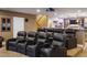 Ultimate home theater with tiered seating, a projector, and a bar area, perfect for entertainment at 7130 Independence St, Arvada, CO 80004