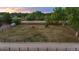 Aerial view of a fenced pasture featuring grazing horses on a sprawling lot at 7130 Independence St, Arvada, CO 80004