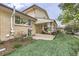 Inviting backyard with covered patio, manicured lawn, and lovely landscaping, perfect for outdoor relaxation at 7552 Miller Ct, Arvada, CO 80005