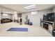 Finished basement with recreational space, a large screen TV, and ample room for activities at 7552 Miller Ct, Arvada, CO 80005