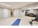 Open basement area with a couch and recreational equipment, offering a versatile space at 7552 Miller Ct, Arvada, CO 80005