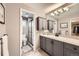 Bathroom features a modern vanity with ample storage, a walk-in shower, and neutral tones at 7552 Miller Ct, Arvada, CO 80005