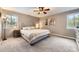 Cozy bedroom with carpet, ceiling fan, and natural light from two windows at 7552 Miller Ct, Arvada, CO 80005