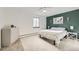 Bright bedroom with accent wall, ceiling fan, carpet and a white dresser, creating a calm space at 7552 Miller Ct, Arvada, CO 80005