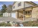Charming two-story home with a brick facade, attached garage, and a cozy covered front porch at 7552 Miller Ct, Arvada, CO 80005