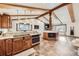 Spacious kitchen with wooden beams, granite counters, stainless appliances, and lots of sunlight at 7552 Miller Ct, Arvada, CO 80005