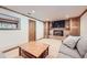 Finished basement featuring a cozy fireplace, built-in cabinets, and comfortable seating at 7552 Miller Ct, Arvada, CO 80005