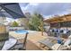 Inviting backyard pool area with ample seating, a pergola, and lush greenery for outdoor enjoyment at 7552 Miller Ct, Arvada, CO 80005