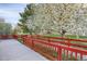 The home's back yard features a red fence, green grass and lush, mature trees at 23730 E Otero Dr, Aurora, CO 80016