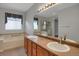 Bright primary bathroom with double vanity, separate shower, and soaking tub at 23730 E Otero Dr, Aurora, CO 80016