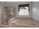 Bathroom with a glass enclosed shower and tub at 23730 E Otero Dr, Aurora, CO 80016
