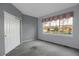 Carpeted bedroom with closet and large window with view of the outdoors at 23730 E Otero Dr, Aurora, CO 80016