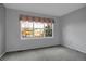 Carpeted bedroom with large window with view of the outdoors at 23730 E Otero Dr, Aurora, CO 80016