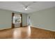 Bright, airy bedroom featuring hardwood floors, a ceiling fan, and large window at 23730 E Otero Dr, Aurora, CO 80016