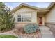 Inviting front entrance with a red door, stone accents, and manicured landscaping at 23730 E Otero Dr, Aurora, CO 80016