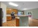 Modern kitchen features stainless steel appliances, light wood cabinets, and a breakfast bar at 23730 E Otero Dr, Aurora, CO 80016