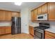Well-equipped kitchen boasting stainless steel appliances, wood cabinets, and white countertops at 23730 E Otero Dr, Aurora, CO 80016