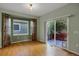 Bright living room with bay window, hardwood floors, and sliding door to the deck at 23730 E Otero Dr, Aurora, CO 80016