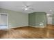 Spacious living room with hardwood floors, a ceiling fan, and neutral green walls at 23730 E Otero Dr, Aurora, CO 80016