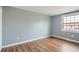 Neutral bedroom with wood floors and a large window overlooking the neighborhood at 2729 E Geddes Pl, Centennial, CO 80122