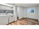 Well-lit laundry area with washer, dryer and wood-look vinyl floors at 2729 E Geddes Pl, Centennial, CO 80122