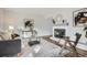 Open concept living area with a fireplace, sleek furniture, and ample natural light at 2729 E Geddes Pl, Centennial, CO 80122
