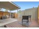 This outdoor patio features wood flooring, a covered area, a small garden, and privacy fencing at 2729 E Geddes Pl, Centennial, CO 80122