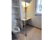 Cozy bathroom featuring toilet, sink, and built-in shelves at 3816 W Dakota Ave, Denver, CO 80219