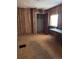 Bedroom with wood paneling, closet, and window with sheer curtains at 3816 W Dakota Ave, Denver, CO 80219