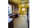 Kitchen area with wood cabinets, laminate countertops, and checkered floor tiles at 3816 W Dakota Ave, Denver, CO 80219